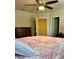 Bright bedroom with a ceiling fan, a view of a walk-in closet and neutral walls at 5108 Caspian St, St Cloud, FL 34771