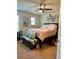 Relaxing bedroom with ceiling fan, comfortable bed, and decorative pelican artwork above a bench at 5108 Caspian St, St Cloud, FL 34771