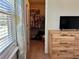 Bedroom with a walk-in closet, neutral carpet, and a wood dresser next to a window at 5108 Caspian St, St Cloud, FL 34771
