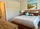 Bedroom with wooden bed frame and ensuite bathroom. Features beach themed artwork and décor at 5108 Caspian St, St Cloud, FL 34771