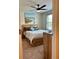 Comfortable bedroom with a ceiling fan and a beach-themed painting above the bed at 5108 Caspian St, St Cloud, FL 34771