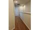 Hallway with neutral carpet and two doors, providing access to various rooms at 5108 Caspian St, St Cloud, FL 34771