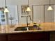 Modern kitchen island features granite countertops, stainless steel sink, and pendant lighting perfect for food preparation at 5108 Caspian St, St Cloud, FL 34771