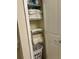 Organized linen closet with shelves for towels and storage for a hamper at 5108 Caspian St, St Cloud, FL 34771