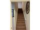 Carpeted staircase with white railing and a decorative clock on the wall going to the second floor at 5108 Caspian St, St Cloud, FL 34771