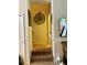 Stairwell view, featuring a decorative clock, stairs and a TV at 5108 Caspian St, St Cloud, FL 34771