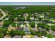 An aerial view showcases the neighborhood with lush greenery and a clear view of the lake at 14867 Bonnybridge Dr, Orlando, FL 32826