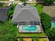 Aerial view of a home with a screened pool enclosure, patio and lush green lawn at 14867 Bonnybridge Dr, Orlando, FL 32826