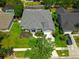 Aerial view of a house with a gray roof, landscaping, manicured lawn and swimming pool at 14867 Bonnybridge Dr, Orlando, FL 32826