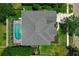 Aerial view of a home featuring a backyard pool with screened enclosure and well-maintained landscaping at 14867 Bonnybridge Dr, Orlando, FL 32826