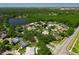 Aerial view of homes nestled in a lush landscape, with a lake and community entrance at 14867 Bonnybridge Dr, Orlando, FL 32826