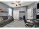 Cozy bedroom with a ceiling fan, a comfortable couch, and a desk area at 14867 Bonnybridge Dr, Orlando, FL 32826