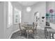 Bright breakfast nook with stylish light fixture and window with plantation shutters at 14867 Bonnybridge Dr, Orlando, FL 32826