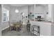 Bright breakfast nook with modern light fixture and kitchen island with barstool seating at 14867 Bonnybridge Dr, Orlando, FL 32826