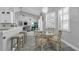 Cozy breakfast nook with round glass table, kitchen island, and plantation shutters at 14867 Bonnybridge Dr, Orlando, FL 32826
