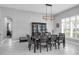 Bright dining room with modern light fixture, black hutch and bench seating at 14867 Bonnybridge Dr, Orlando, FL 32826