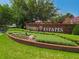 University Estates entrance sign with a brick base, landscaping, and a bird statue at 14867 Bonnybridge Dr, Orlando, FL 32826