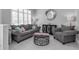 Cozy living room with plush grey seating, round coffee table and shuttered window at 14867 Bonnybridge Dr, Orlando, FL 32826