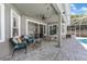 Covered outdoor patio with brick flooring, ceiling fan, and comfortable seating, great for entertaining at 14867 Bonnybridge Dr, Orlando, FL 32826