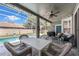 Outdoor patio with a grill, comfy seating and a table with chairs next to the screened in pool at 14867 Bonnybridge Dr, Orlando, FL 32826