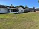 Expansive backyard features a large grassy area and a screened-in porch for outdoor enjoyment at 3295 Se 56Th Ave, Ocala, FL 34480