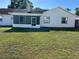 The backyard features a well-maintained lawn and screened-in porch, perfect for outdoor relaxation at 3295 Se 56Th Ave, Ocala, FL 34480