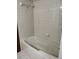 Cozy bathroom featuring tiled walls, a bathtub, and essential fixtures at 3295 Se 56Th Ave, Ocala, FL 34480