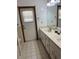 Bathroom featuring tiled floor, double vanity, and a door with window at 3295 Se 56Th Ave, Ocala, FL 34480