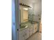 An older bathroom featuring double sinks, vintage light fixtures and large mirrors at 3295 Se 56Th Ave, Ocala, FL 34480