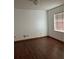 Cozy bedroom featuring wood-look flooring, neutral paint, and natural light at 3295 Se 56Th Ave, Ocala, FL 34480