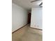 A simple bedroom features neutral walls and carpet, leading to a wooden door at 3295 Se 56Th Ave, Ocala, FL 34480