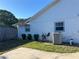 The exterior showcases the property's modern white design, complemented by manicured landscaping at 3295 Se 56Th Ave, Ocala, FL 34480