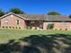 Charming brick home featuring a well-manicured lawn and inviting front entrance at 3295 Se 56Th Ave, Ocala, FL 34480