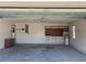 A spacious garage features overhead lighting and storage solutions along the walls at 3295 Se 56Th Ave, Ocala, FL 34480