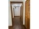 Hallway with wood-look flooring, neutral paint, and wood-look doors and trim at 3295 Se 56Th Ave, Ocala, FL 34480