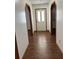 Hallway with wood-look flooring, neutral paint, archway entry and a glass front door at 3295 Se 56Th Ave, Ocala, FL 34480