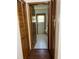 Hallway view leading into a bathroom with tiled floor and door with window at 3295 Se 56Th Ave, Ocala, FL 34480