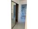 Hallway featuring mirror closet and tiled bathroom with shower at 3295 Se 56Th Ave, Ocala, FL 34480