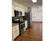 Modern kitchen with stainless steel appliances, mosaic backsplash, and white cabinetry at 3295 Se 56Th Ave, Ocala, FL 34480