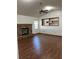 Bright living room featuring a brick fireplace, ceiling fan, and wood-look flooring at 3295 Se 56Th Ave, Ocala, FL 34480