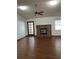 A living room offers hardwood floors, a brick fireplace, and bright, natural light at 3295 Se 56Th Ave, Ocala, FL 34480