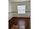 A room showcases hardwood floors and a window with blinds for natural light at 3295 Se 56Th Ave, Ocala, FL 34480