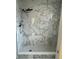 A modern bathroom includes a shower with elegant white and gray marble-patterned tiles at 3295 Se 56Th Ave, Ocala, FL 34480