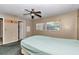 Bedroom with ceiling fan, window, and access to bathroom, ideal for comfortable living at 8082 Sw 103Rd Ln, Ocala, FL 34481