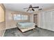 Bedroom with a ceiling fan, window, and closets, providing ample storage and natural light at 8082 Sw 103Rd Ln, Ocala, FL 34481