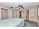 Bedroom featuring a ceiling fan, multiple closets, and access to a bathroom, creating a functional space at 8082 Sw 103Rd Ln, Ocala, FL 34481