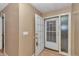 Foyer with an open door and neutral decor that creates a warm and welcoming atmosphere at 8082 Sw 103Rd Ln, Ocala, FL 34481