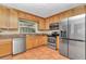 Spacious kitchen features stainless steel appliances, ample counter space, and tile flooring at 8082 Sw 103Rd Ln, Ocala, FL 34481