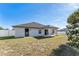 View of the backyard featuring a covered patio and a well-maintained exterior, creating a peaceful outdoor space at 9945 Sw 55Th Avenue Rd, Ocala, FL 34476
