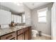 Well-lit bathroom features granite counters, stylish fixtures, and neutral color palette at 9945 Sw 55Th Avenue Rd, Ocala, FL 34476